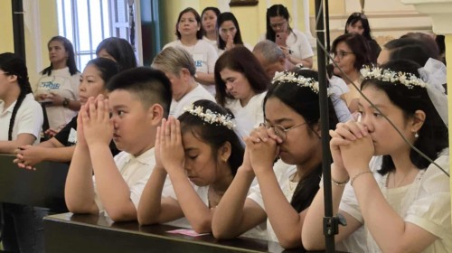 Corpus Christi as Four (4) faithful received the Sacrament of Communion